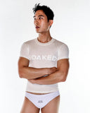 Man wearing a 'SOAKED' t-shirt and white underwear on a white background
